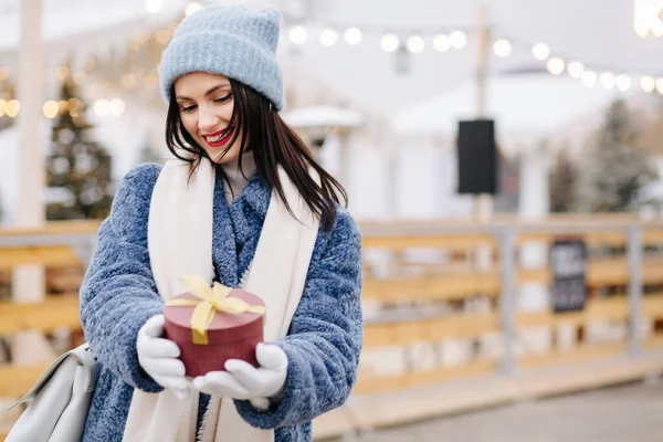 Happy Brunette Woman Wears Knitted Cap Blue Coat Holding Red — Stock Photo, Image
