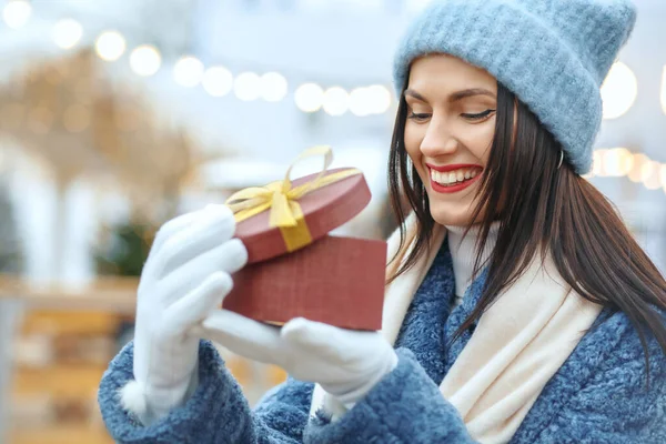 Cheerful Brunette Woman Winter Coat Holding Gift Box Christmas Fair — Stock Photo, Image