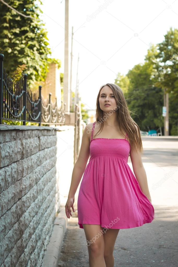 Attractive woman walking on the street in summer