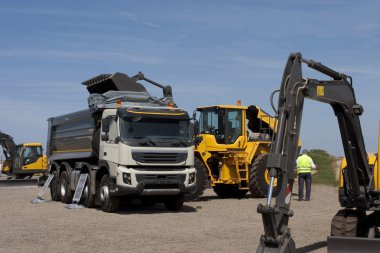 Truck and bulldozer work in the quarry clipart