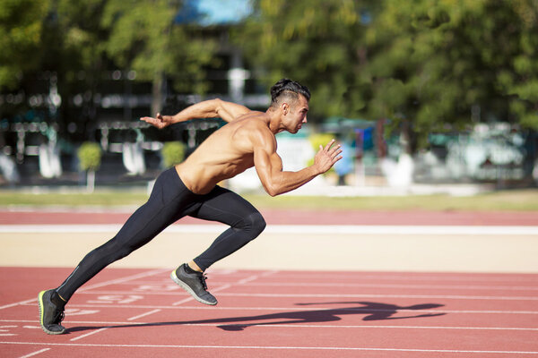 Sprinter leaving  on the running track. 