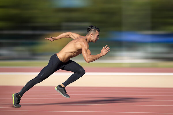 Sprinter leaving  on the running track. 