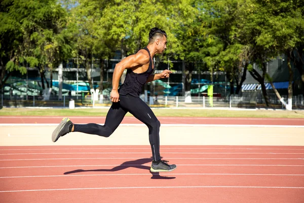 Young muscular man ready to start a track meet. — Stock Photo, Image