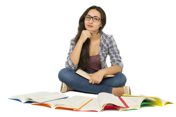 Young student surrounded by books — Stock Photo, Image