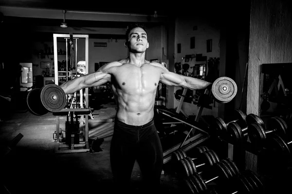 Young man exercising in dark and old gym Stock Photo by ©camaralenta  144238833