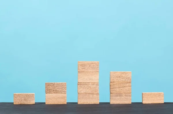 Wooden block stacking as step stair  on green background, Ladder of success in business growth concept, copy space