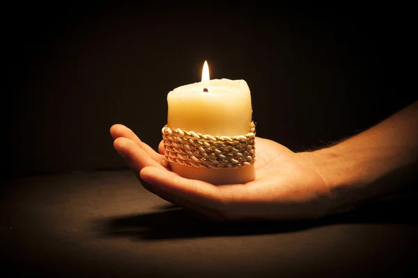 Hands with candle — Stock Photo, Image