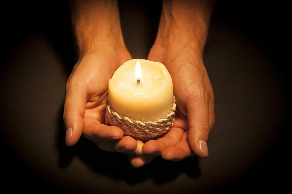 Hands with candle — Stock Photo, Image