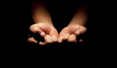 Praying Hands in black background clipart