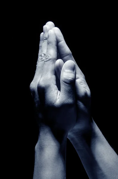 Hands together in prayer Stock Photo