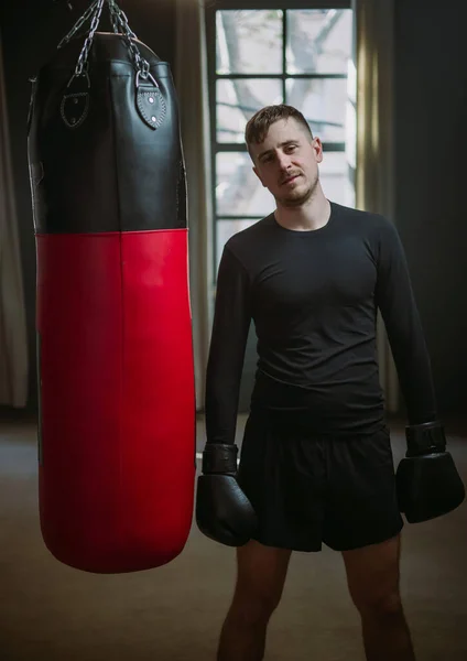 The man is an athlete boxing in the gym. Boxer practicing punches in the ring. Shadow-boxing. The athlete strikes with a punching bag. 4k video Royalty Free Stock Photos