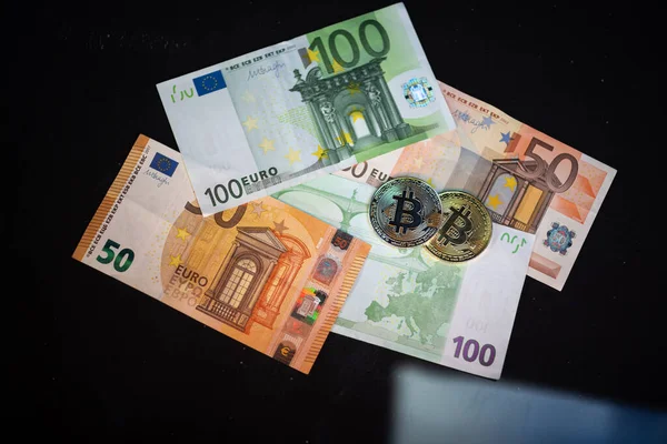 Bitcoin and money. Euro banknotes. Cryptocurrency bitcoin. Slow-motion video. Royalty Free Stock Images