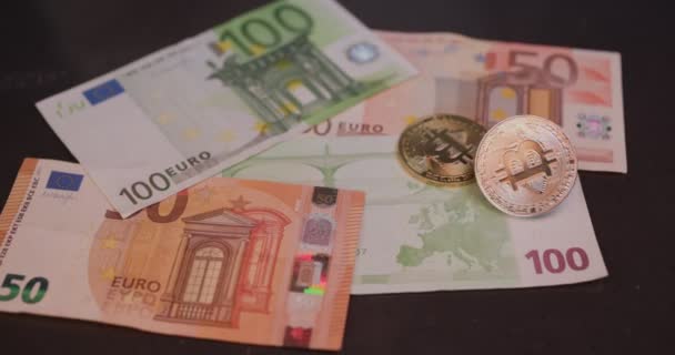 Bitcoin and euro banknotes. Crypto currency bitcoin. A gold coin. Slow-motion video. — Stock Video
