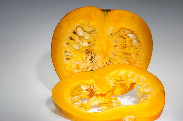 半橙色南瓜，带切片和种子 — 图库照片