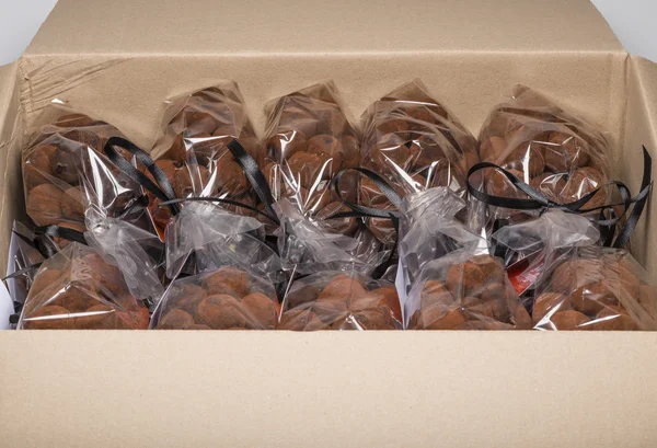 Delicious chocolate truffle bags stacked in a carton — Stock Photo, Image