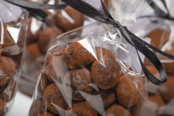 Chocolate truffles in luxury bags with focus on foreground