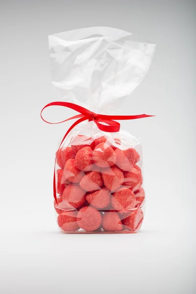 Luxury bag of acidulous strawberries isolated with elegant red r — Stock Photo, Image