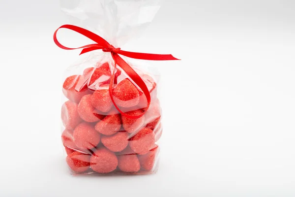 Elegant plastic bag of sugar strawberries with red ribbon — Stock Photo, Image