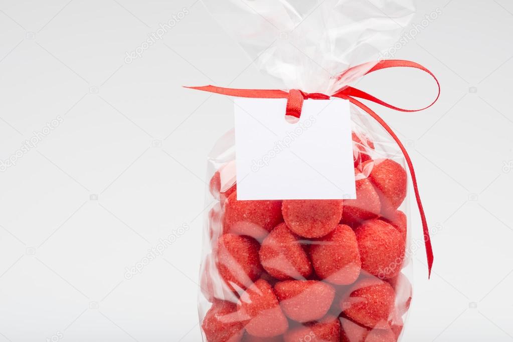 Closeup of luxury bag of  sugar strawberries with red ribbon