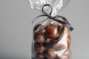 Luxury bag of fresh chestnuts with ribbon and copy space