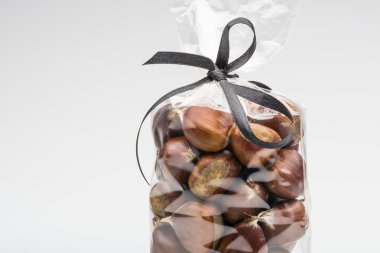 Elegant bag of sweet chestnuts with ribbon and copy space
