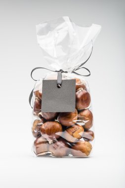 Contemporary gift with ribbon of chestnuts with black blank labe