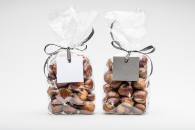 Two elegant plastic bags of fresh chestnuts for gift with black and white blank labels
