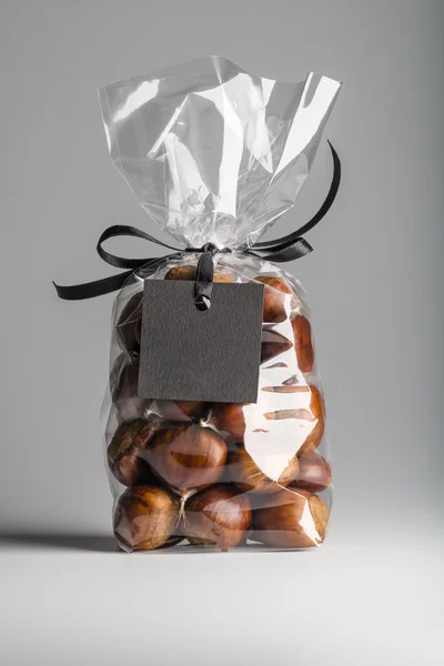 Luxury gift with ribbon of chestnuts with black blank label — Stok fotoğraf