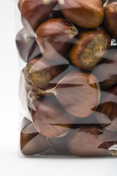 Macro of fresh chestnuts in luxury plastic bag — Stok fotoğraf