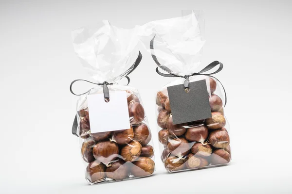 black and white blank gift tags with ribbon on two chocolate truffles bags