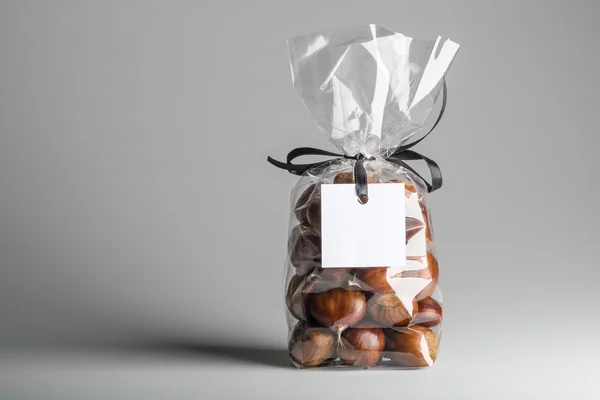 Bag of chestnuts with blank label and copy space — Stok fotoğraf