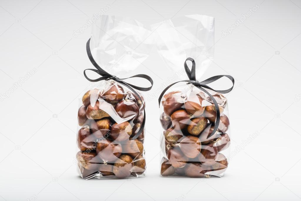 Couple of elegant plastic bags of fresh chestnuts for gift