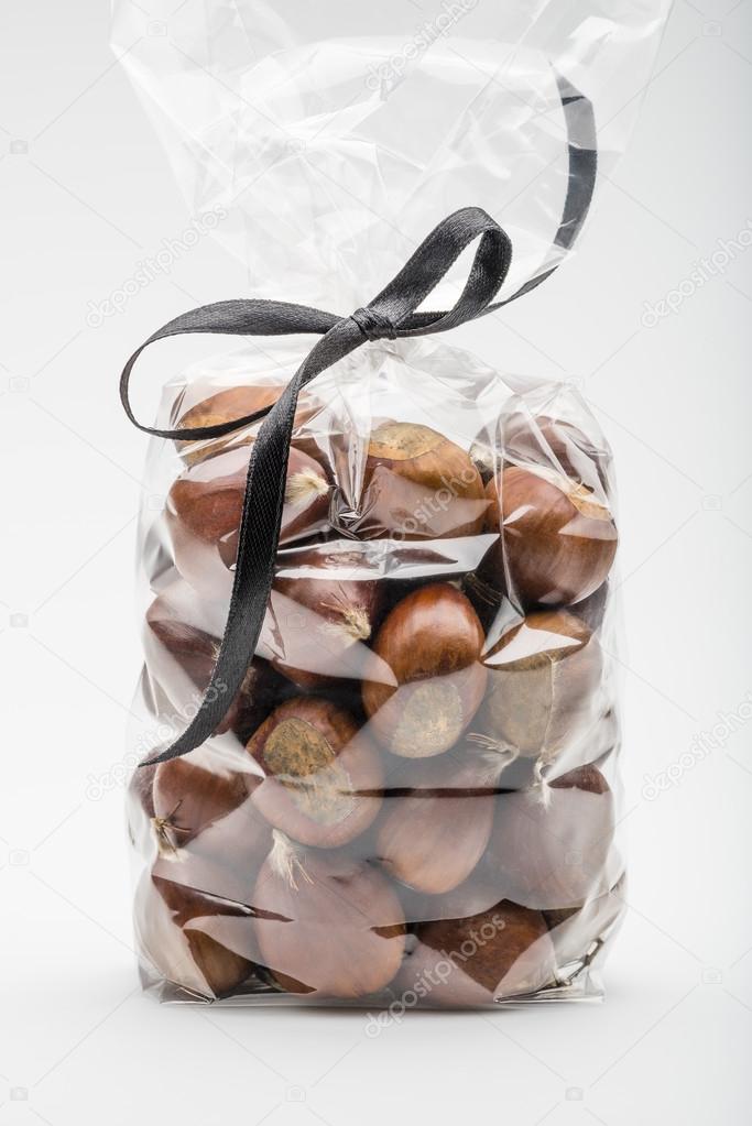 Contemporary  bag of sweet chestnuts with elegant black ribbon