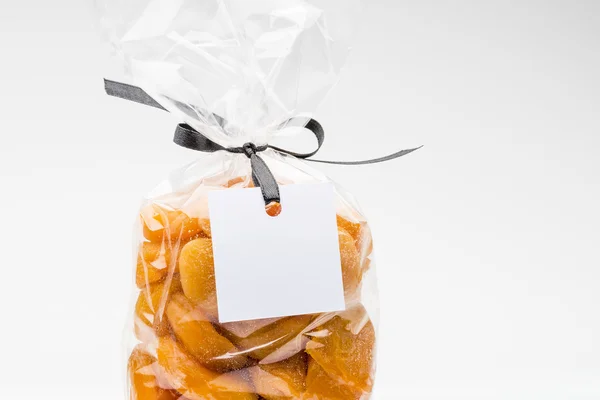Closeup on bag of organic dried apricots with blank label — Stock Photo, Image