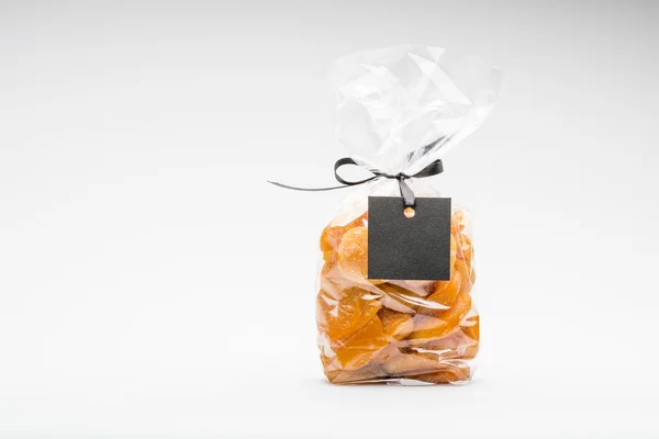 Bag of dried apricots isolated on white and blank label — Stock Photo, Image