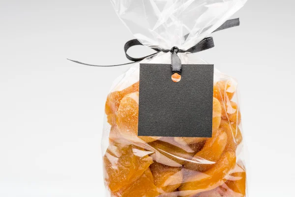 Closeup on luxury bag of dried apricots with blank label — Stock Photo, Image