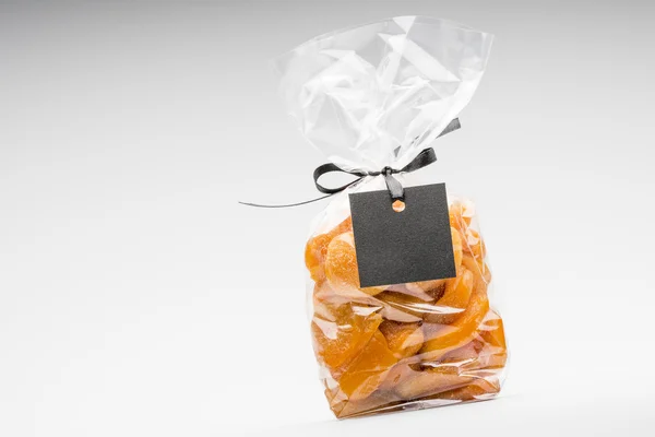 Bag of candied apricots isolated on white and blank label — Stock Photo, Image