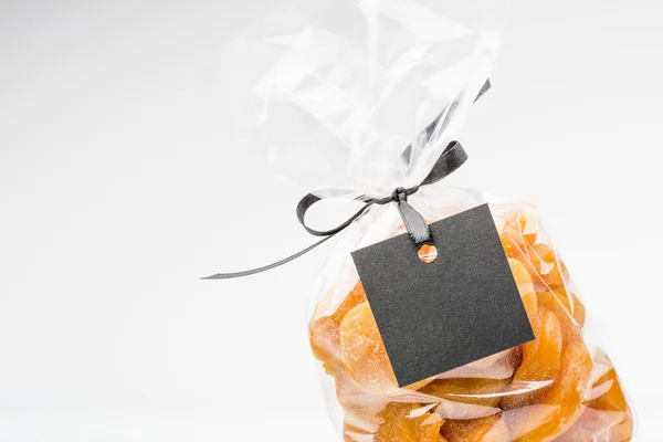 Closeup on transparent bag of dried apricots with blank label