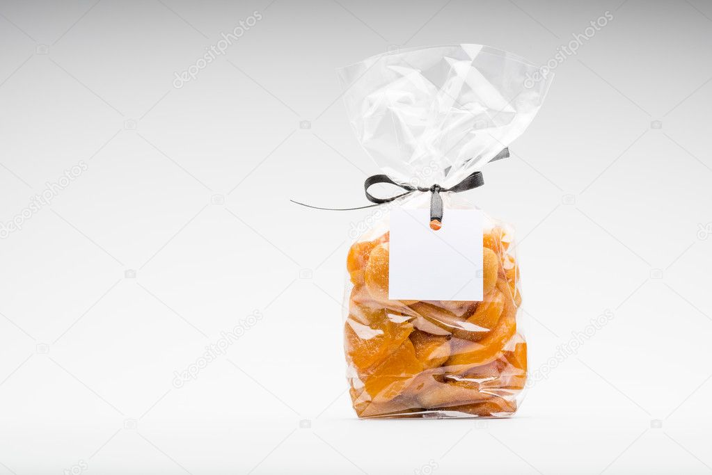 Bag of dried apricots isolated on white and blank label