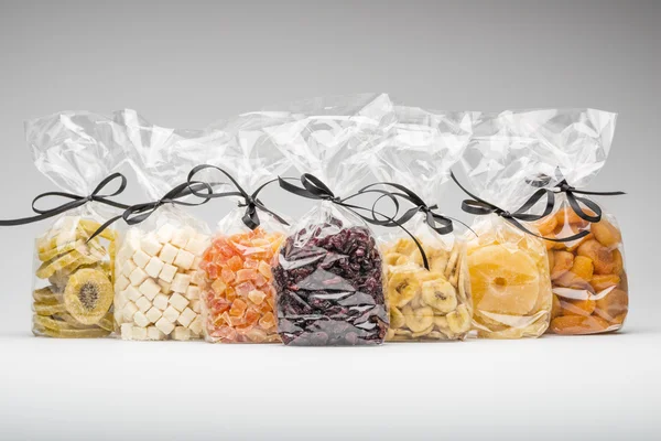 Seven luxury plastic bags of various dried fruits for gift — Stock Photo, Image