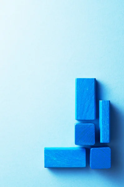 Сині дерев'яні кубики над синім — стокове фото