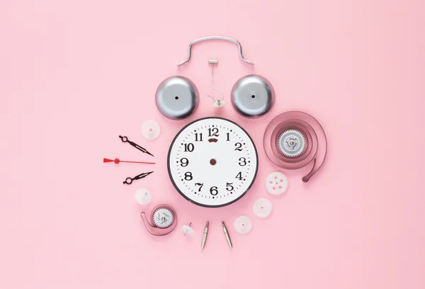 Clock components organized over pink — Stock Photo, Image