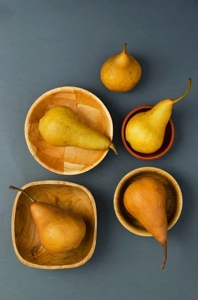Ripe pears in different bowls — Stock Photo, Image