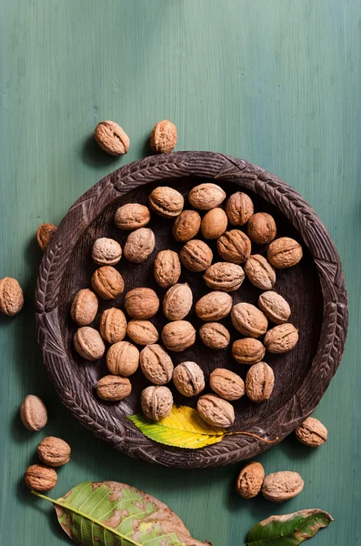 Fresh walnuts in rustic bowl — Stock Photo, Image