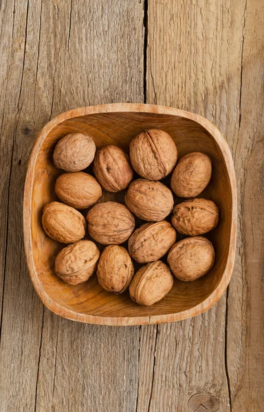Walnuts in rustic bowl — Stock Photo, Image