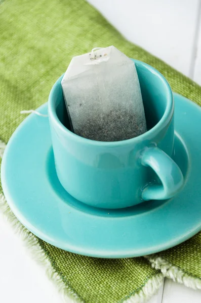 Mint tea bag in blue cup — Stock Photo, Image