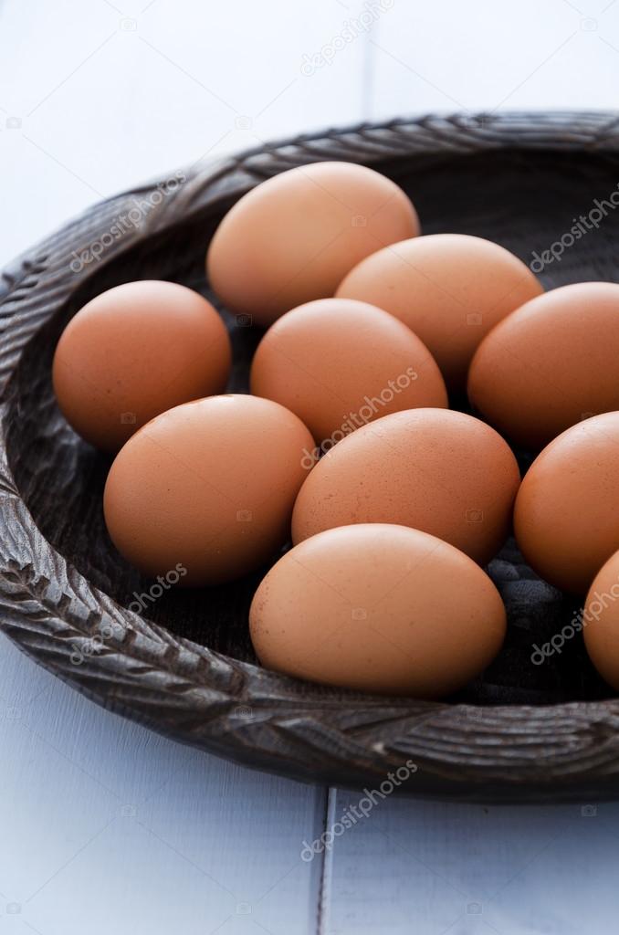Eggs on rustic wooden plate 