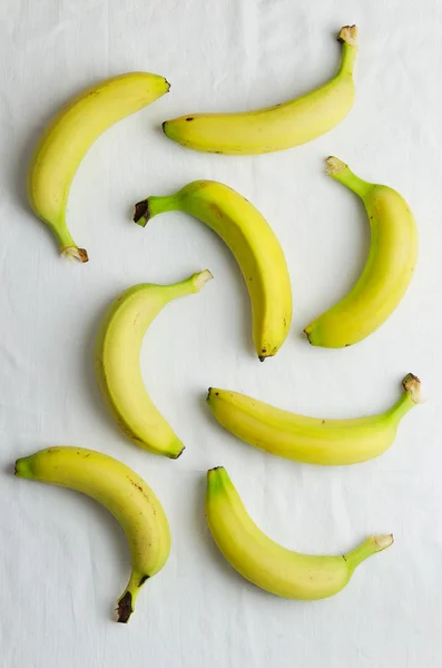 Bananas over white cloth — Stock Photo, Image