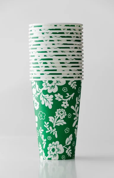 Green paper cup with flowers pattern — Stock Photo, Image