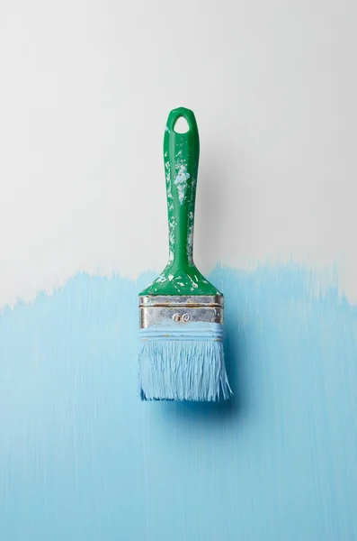 Paintbrush with blue paint streaks — Stock Photo, Image